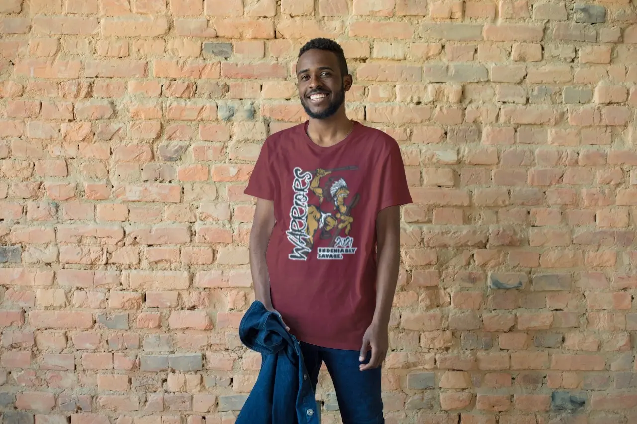 Man wearing a Warriors fan shirt while holding a jacket in his hand